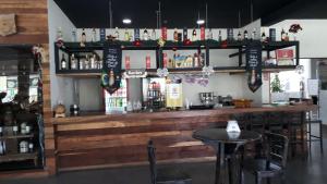 a bar in a restaurant with a wooden counter at Lindo Flat no Aldeias das Águas in Barra do Piraí