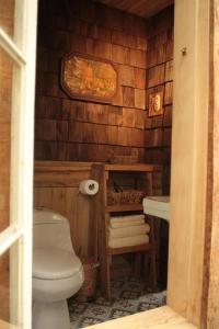 a bathroom with a toilet and a sink at La Casita del Bosque in Castro