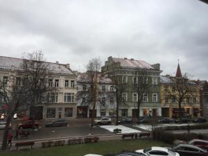 a group of buildings with cars parked in a parking lot at Town Hall Apartments in Vilnius