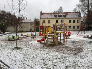 a playground in a yard covered in snow at Town Hall Apartments in Vilnius