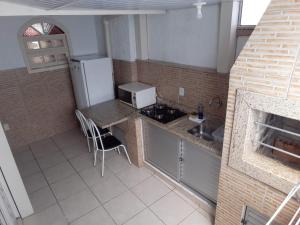 a small kitchen with a sink and a refrigerator at AP Floripa in Florianópolis