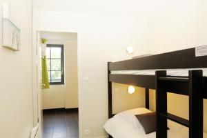 a bedroom with a bunk bed in a room at Hôtel Restaurant Corto Maltese in Le Palais