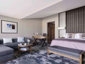 a room with a bed and a couch and a table at InterContinental Sofia by IHG in Sofia