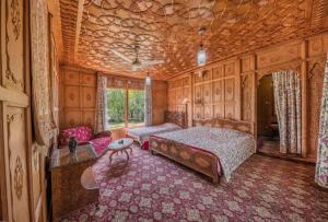 a large bedroom with a bed and a couch at S Group Of Houseboat in Srinagar