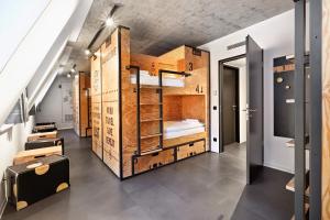 a room with a bunk bed in a loft at H.ostel Münster in Münster