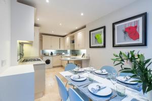 a kitchen and dining room with a table and chairs at ALTIDO Stylish 3 bed mews house with patio in Marylebone in London