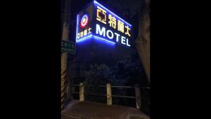 a sign for a motel is lit up at night at Yatelanda Motel in Shalu