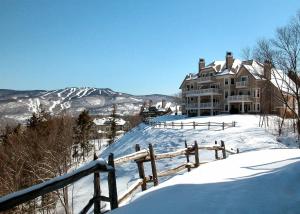 a house on top of a snow covered mountain at Cap Tremblant Mountain Resort in Mont-Tremblant