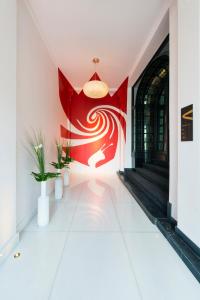 a hallway with a red flag on the wall at Hotel The Royal Snail in Namur