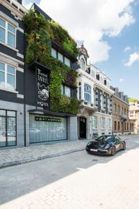 a black car parked in front of a building at Hotel The Royal Snail in Namur