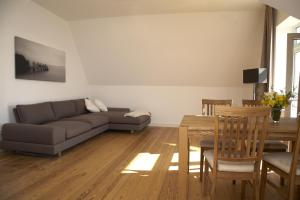 a living room with a couch and a table at Ferienwohnungen Schlei 42 in Schleswig
