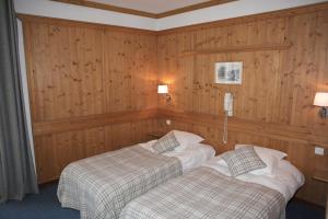 Postel nebo postele na pokoji v ubytování Hôtel Val d'Este
