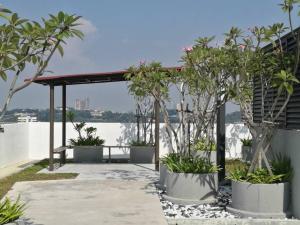 a pergola with trees and a view of the water at Rumah Cik Ani in Shah Alam