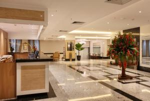 a lobby of a hotel with a plant on the floor at Windsor Florida Hotel in Rio de Janeiro