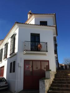 a white house with a red garage at Casa Rural Miradas De Aracena in Aracena