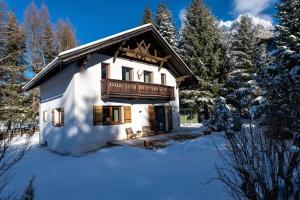 a house with a balcony in the snow at Schneehaus Lodge in Ehrwald