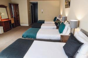 Ein Bett oder Betten in einem Zimmer der Unterkunft Hotel Corner House