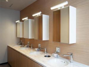 a bathroom with three sinks and two mirrors at 9 C Hotel Asahikawa in Asahikawa
