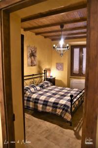 a bedroom with a bed and a chandelier at La Casa di Nonna in Tivoli
