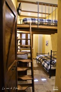 a room with two bunk beds and a staircase at La Casa di Nonna in Tivoli