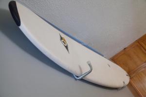 a surfboard is hanging on a wall at Goldcrest House by RentMyHouse in Hereford