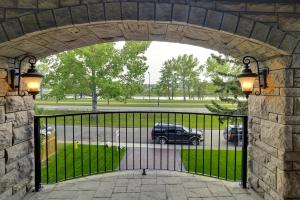 an entrance to a gate to a parking lot at Westmount River Inn in Calgary