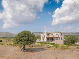 a large house in the middle of a field at Afrala Summerhouse in Chavriáta