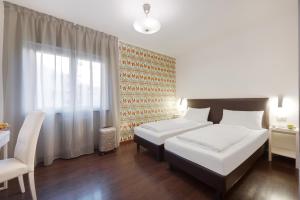 Posteľ alebo postele v izbe v ubytovaní Hotel Asterix