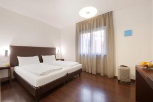 Postel nebo postele na pokoji v ubytování Hotel Asterix