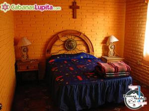 a bedroom with a bed in a brick wall at Cabañas Lupita 31 in Mazamitla