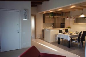 a kitchen and dining room with a table and chairs at Il Piccolo Rifugio - L'Angoletto in Palidoro