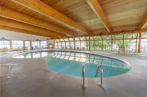 a swimming pool in a building with a wooden ceiling at Terrace Bay Hotel - Lakefront in Escanaba