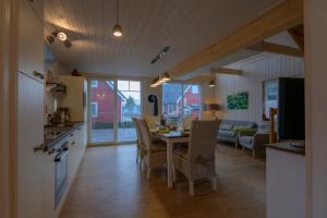 a kitchen and dining room with a table and chairs at Haus Michel in Wandlitz