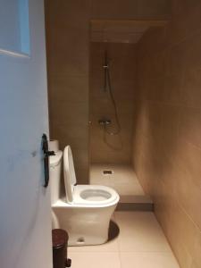 a bathroom with a toilet and a shower at Jordan River Hotel in Amman