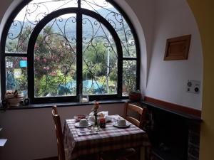 a table in a room with a large window at Agriturismo Mare e Monti in Tramonti