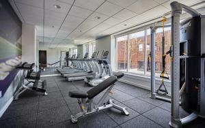 a gym with a row of treadms and machines at Graduate Seattle in Seattle