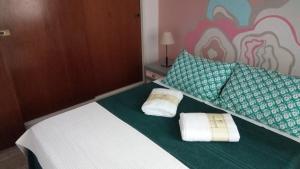 a bedroom with a bed with two towels on it at Apartamento La Loca del Pincel in Buenos Aires