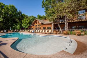 a swimming pool in front of a house at The Village At Indian Point Resort in Branson