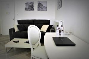 a living room with a table and a laptop on a chair at Hermes rooms for tourists in Naples