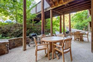 a patio with tables and chairs and a grill at The Village At Indian Point Resort in Branson