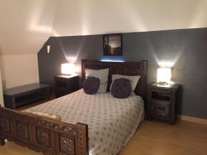 a bedroom with a wooden bed with two night stands and two lamps at Loire Terrasse in Tours