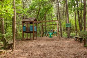 a park with a playground in the woods at The Village At Indian Point Resort in Branson