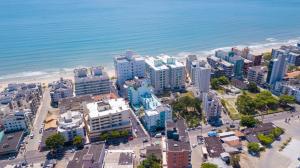 an aerial view of a city and the ocean at Solis Praia Hotel Itapema in Itapema