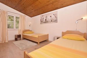 Posteľ alebo postele v izbe v ubytovaní Apartments Mladen