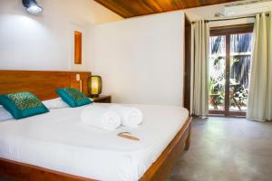 Makao Beach Hotel客房内的一张或多张床位