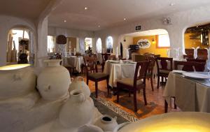 a restaurant with tables and chairs and a vase at San Agustin Internacional in Cusco +43 photos