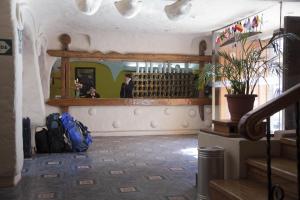 a room with a mirror and a woman standing in a bar at San Agustin Internacional in Cusco