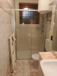 a bathroom with a shower and a toilet and a sink at Angela di Venezia House in Venice