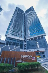 a tall building with a tesco sign in front of it at Teega Suites by JBcity Home in Nusajaya