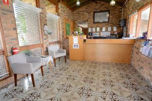 a restaurant with chairs and a counter in a room at Sandhurst Motor Inn Bendigo in Bendigo